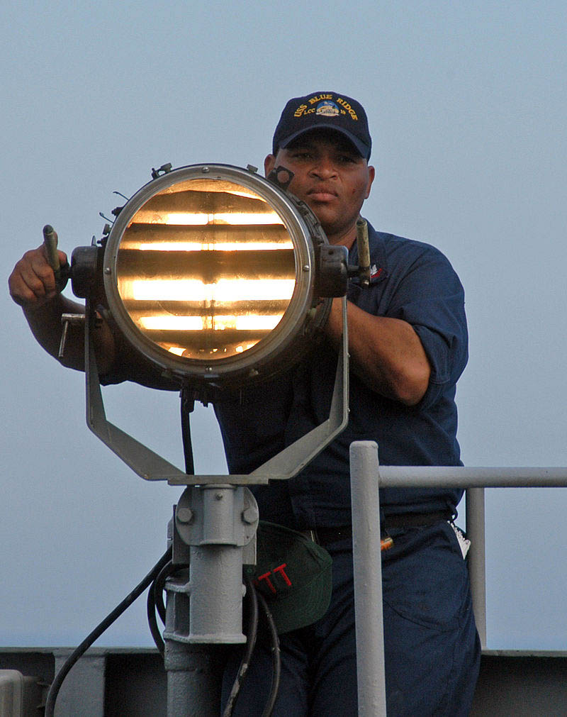 man on ship sending morse code